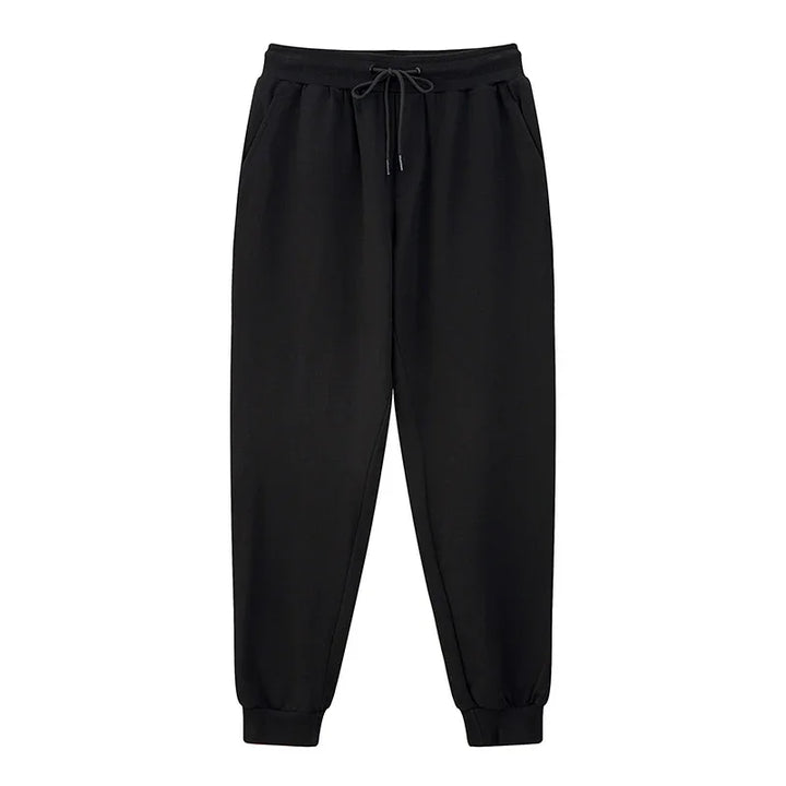 Black casual jogger pants with elastic waistband, drawstring, side pockets, and cuffed ankles
