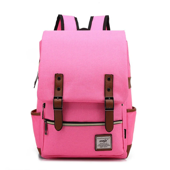 Pink canvas backpack with brown leather straps, front zipper pocket, and side pockets