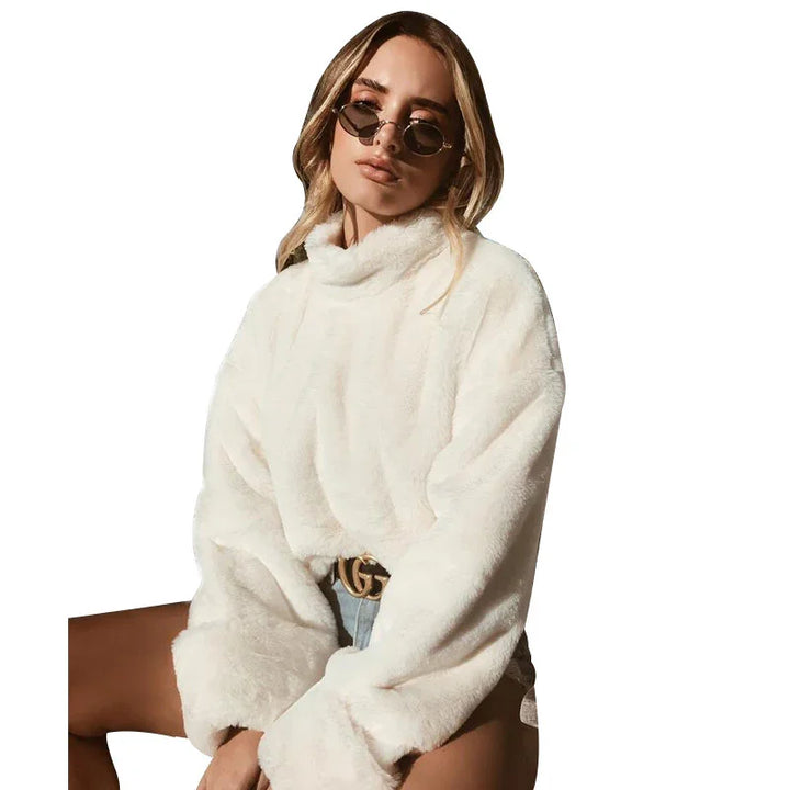 Woman wearing white faux fur sweater, sunglasses, and denim shorts with designer belt
