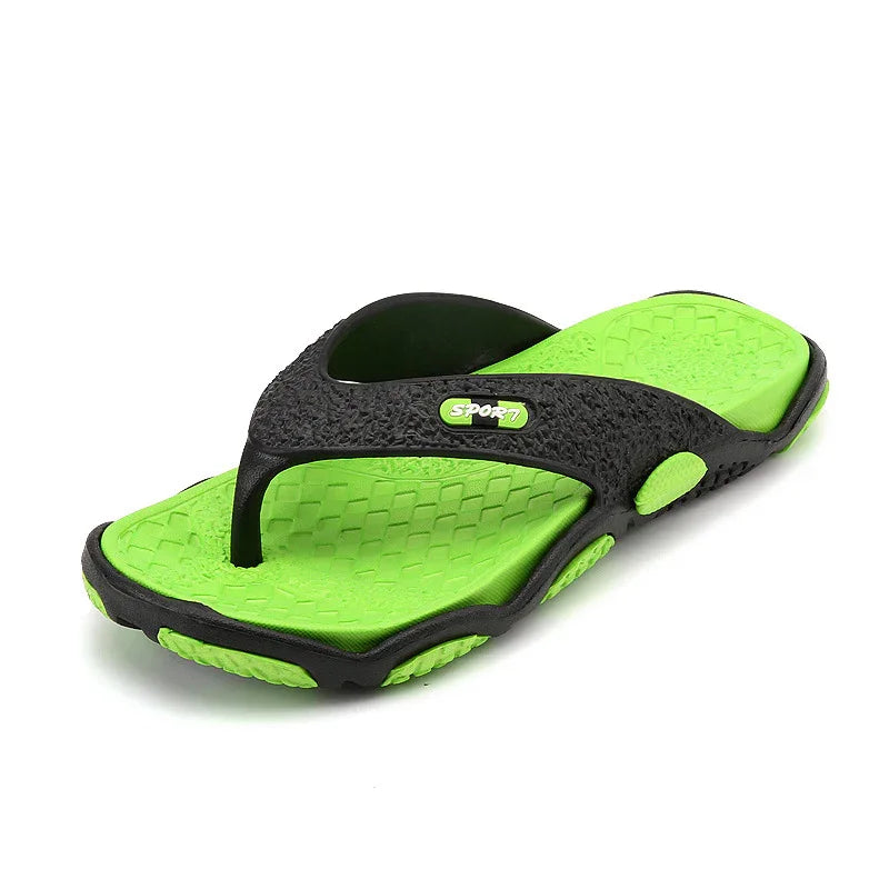 Black and green sport flip flop sandal with textured sole and toe post