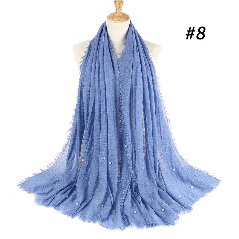 Light blue crinkle texture scarf with small pearl embellishments displayed on a mannequin