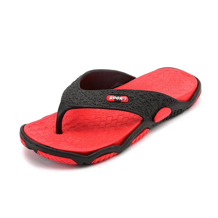 Red and black sport flip flops with textured sole and cushioned straps on white background