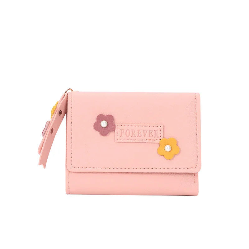 Pink compact wallet with floral decorations and 'FOREVER' label on front flap