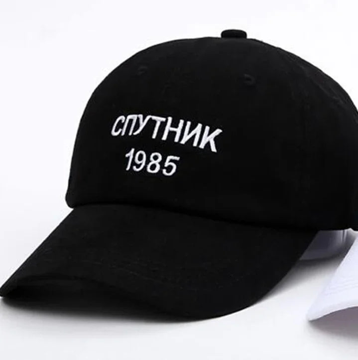 Black baseball cap with white Cyrillic text 'СПУТНИК' and number '1985' embroidered on front
