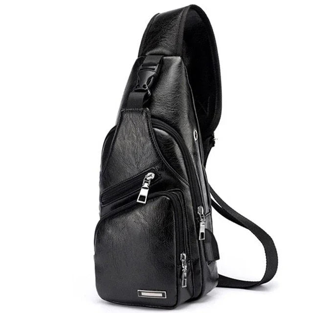 Black leather sling backpack with multiple zippered compartments and adjustable strap