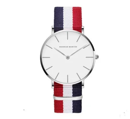 Minimalist wristwatch with white dial and red, white, blue striped fabric strap