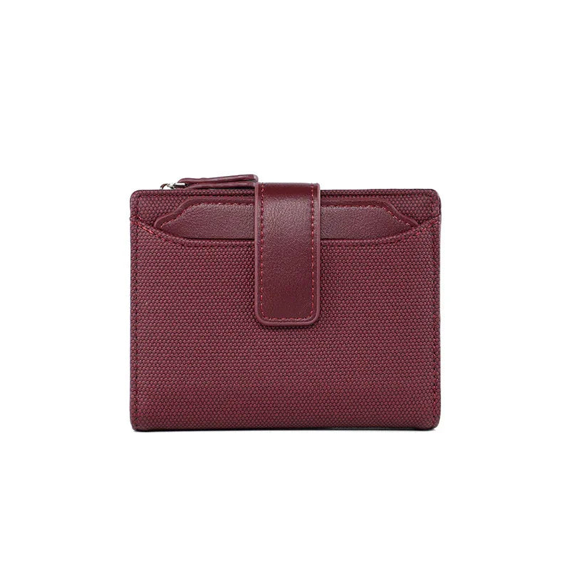 Compact burgundy textured fabric wallet with leather strap and zippered coin pouch