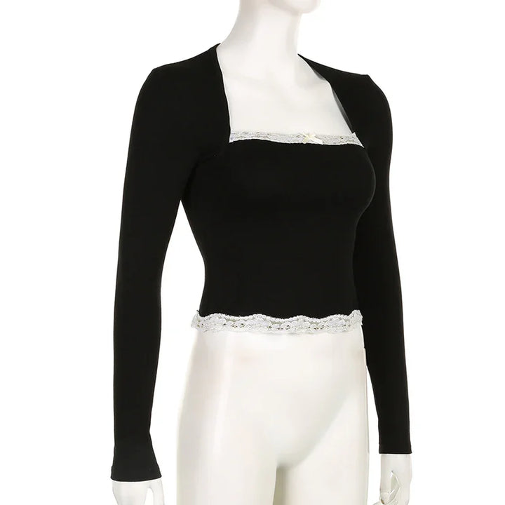 Black long-sleeve bolero shrug paired with black square-neck crop top featuring white lace trim