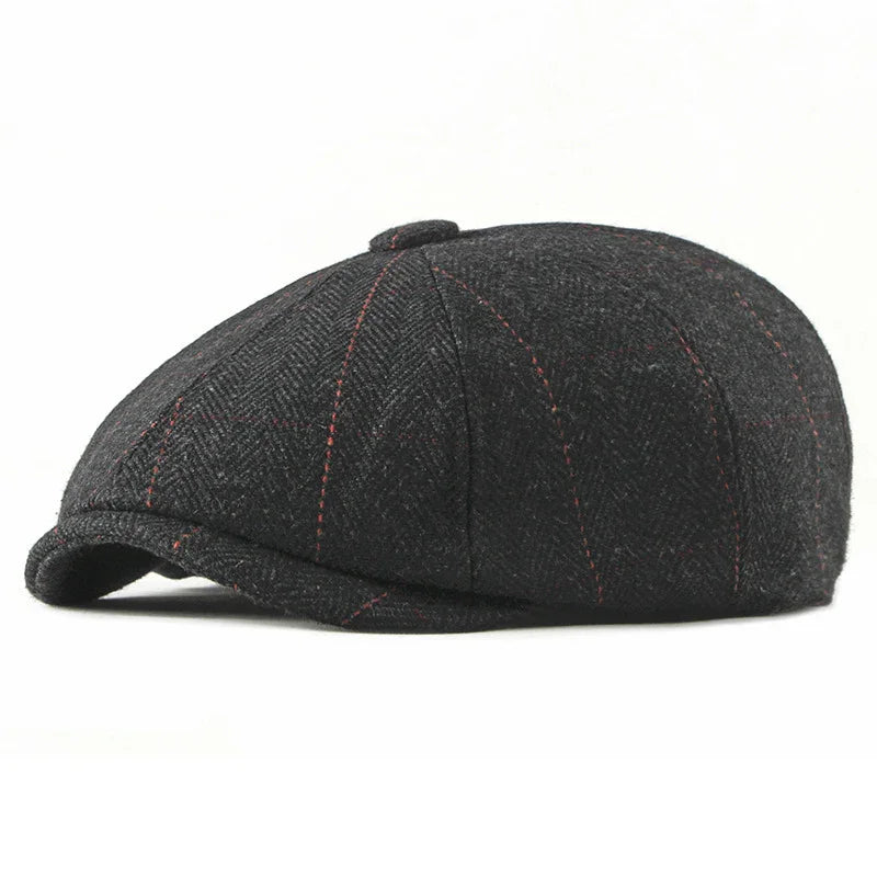 Black tweed flat cap with red stitching and herringbone pattern on white background