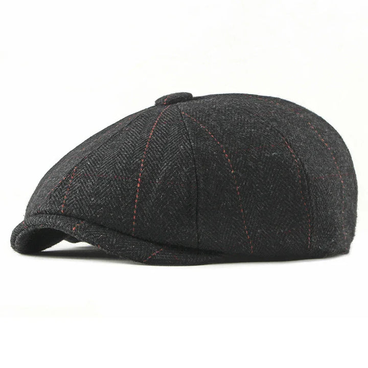 Black tweed flat cap with red stitching and herringbone pattern on white background