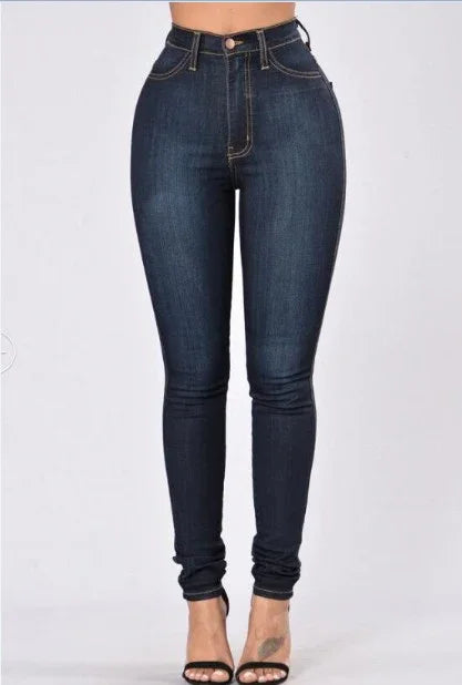 High-waisted dark blue skinny jeans with contrast stitching paired with black open-toe heels
