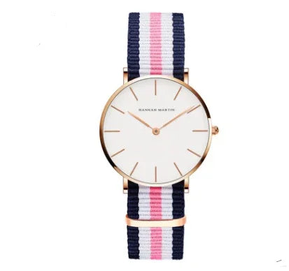 Minimalist wristwatch with white dial, rose gold case, and navy pink striped fabric strap