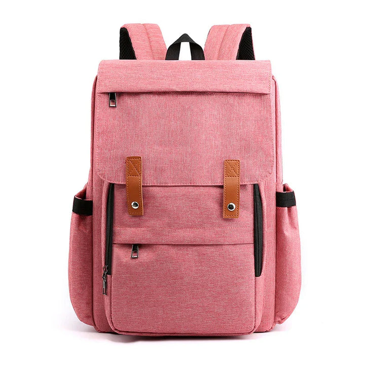 Stylish pink backpack with brown leather straps, multiple zippered pockets, and padded shoulder straps