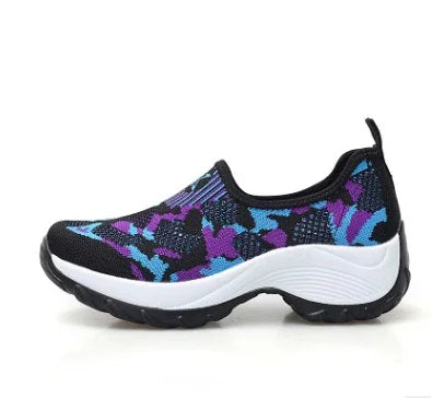 Black slip-on sneaker with blue and purple camouflage pattern and white thick sole