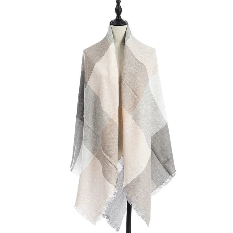 Soft beige and gray plaid checkered shawl with fringed edges displayed on black mannequin