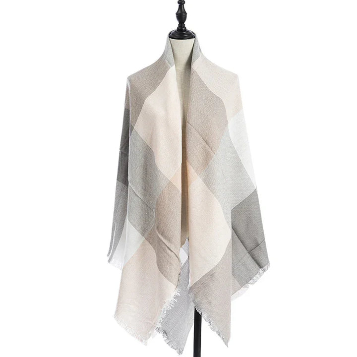Soft beige and gray plaid checkered shawl with fringed edges displayed on black mannequin