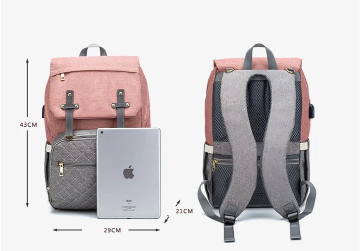 Pink and gray backpack with front pocket, adjustable straps, and USB charging port, shown with iPad and dimensions