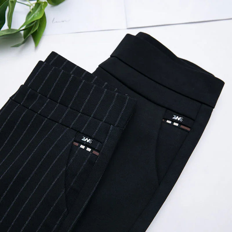 Two pairs of black dress pants, one with pinstripes and one solid, displayed flat with pockets visible