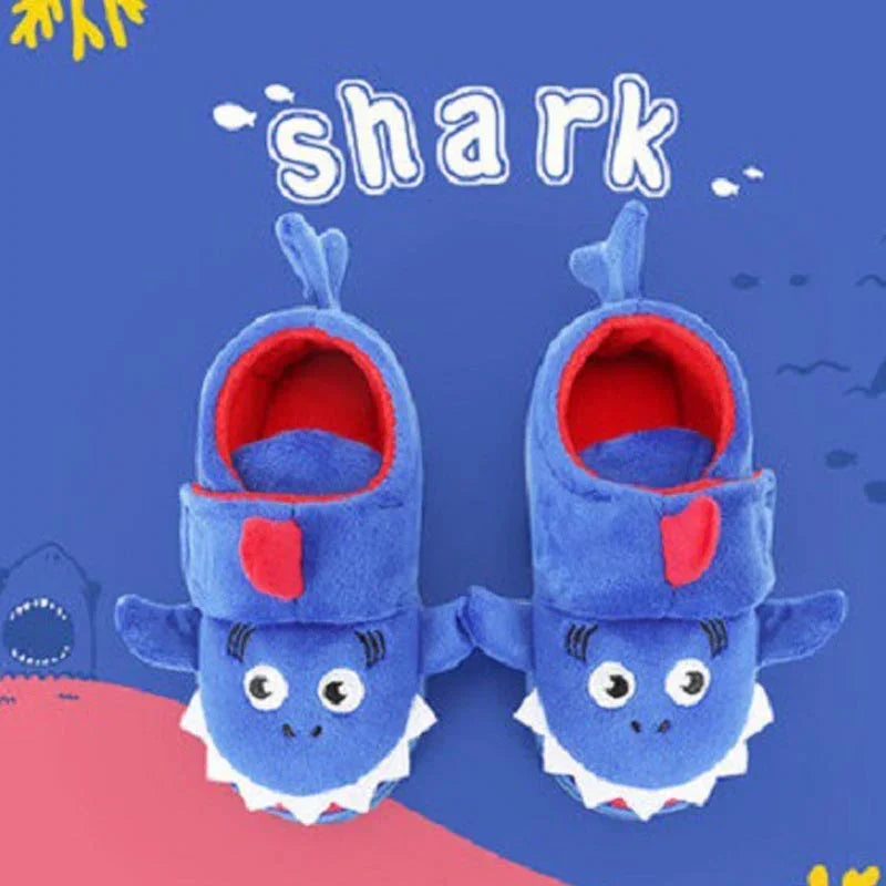 Cute blue and red plush shark slippers for kids on a blue and pink background with shark text