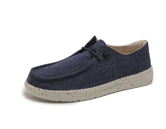 Casual men's navy fabric shoe with beige speckled sole and black laces