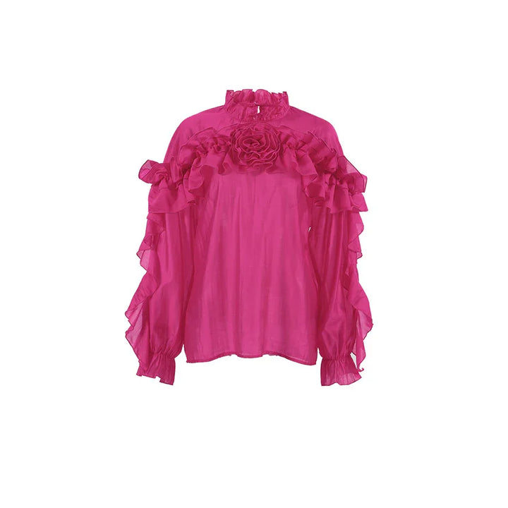 Bright pink long sleeve blouse with ruffled collar and floral center detail
