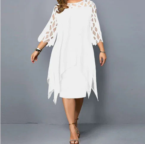 Woman wearing white knee-length dress with patterned cutout sleeves and asymmetrical hem