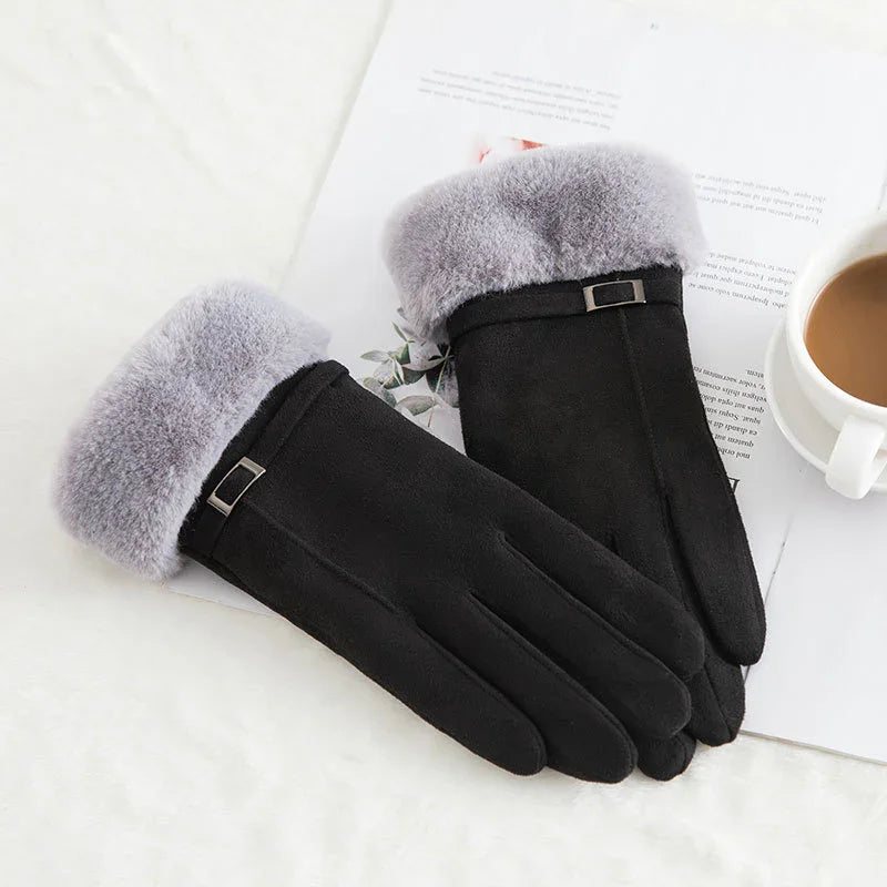 Black winter gloves with soft gray fur cuffs and small buckle detail on white background