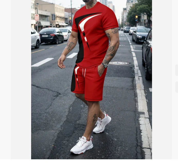 Man wearing red and black graphic t-shirt and shorts with white sneakers walking on city street