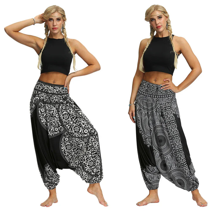 Woman wearing black crop top and two styles of black and white patterned harem pants with barefoot pose