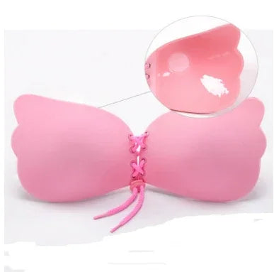 Pink adhesive strapless butterfly-shaped bra with lace-up front and smooth wings