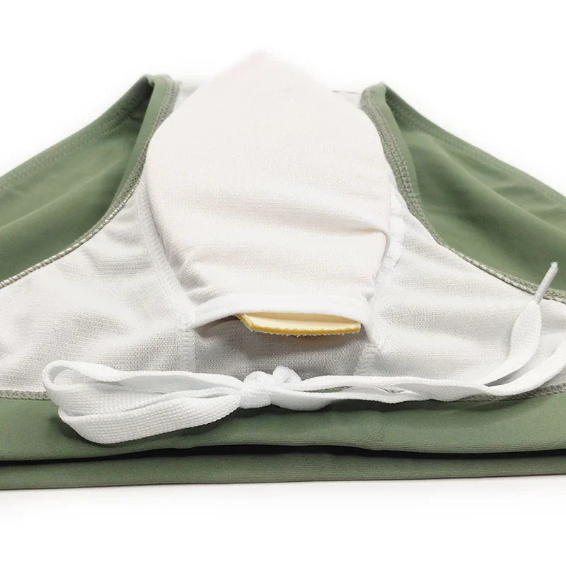 Close-up of green and white sports bra with adjustable tie and soft fabric detail