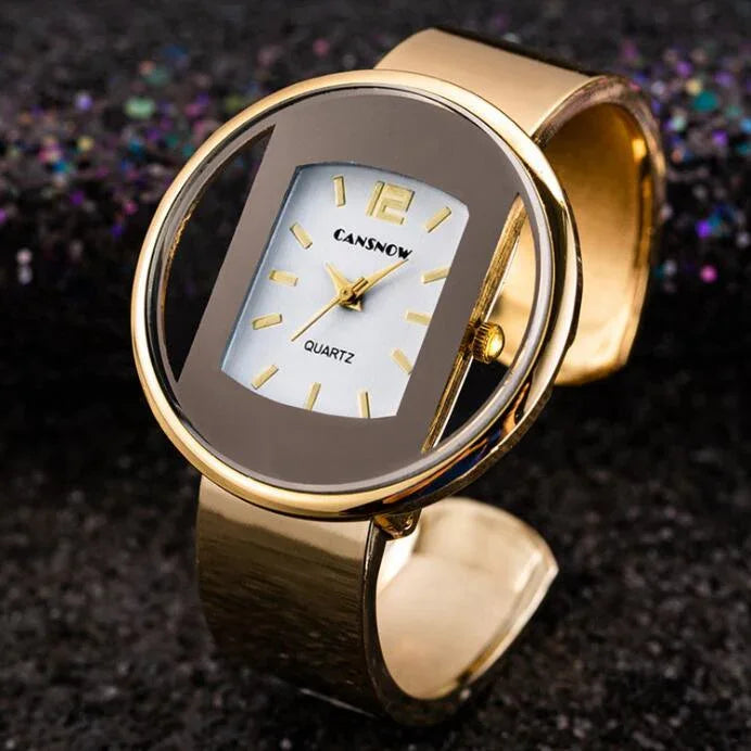 Close-up of a gold CANSNOW quartz wristwatch with a unique oval transparent case and gold band on black glitter background