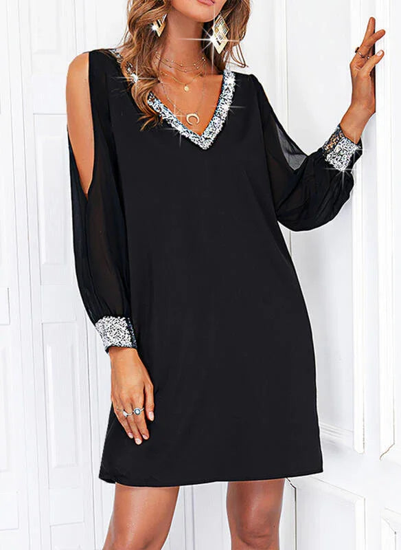 Black cold-shoulder dress with silver sequin trim on V-neckline and cuffs, sheer long sleeves