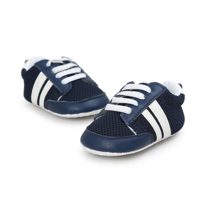 Pair of navy blue baby shoes with white laces and two white stripes on sides