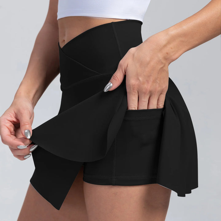 Close-up of a woman wearing high-waisted black athletic skort with side pocket for essentials