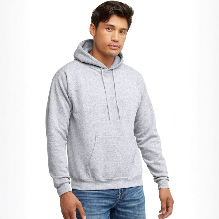 Man wearing a plain light gray hoodie with front pocket and drawstrings, paired with blue jeans
