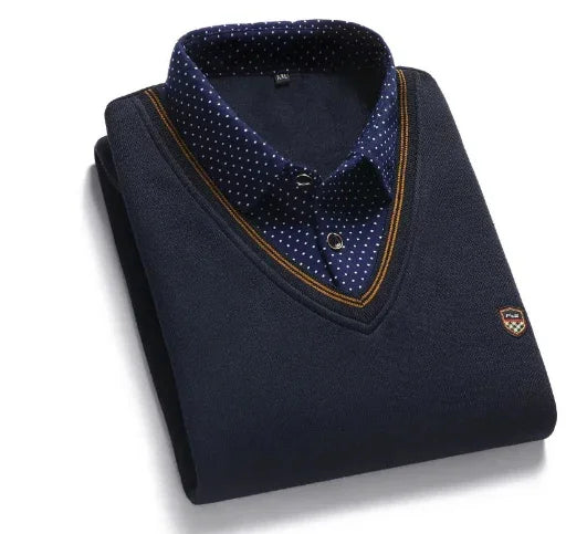Folded navy blue V-neck sweater with a brown-striped collar over a navy blue polka dot button-up shirt