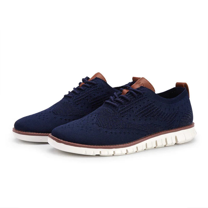 Men's navy blue knitted casual shoes with white sole and brown leather accents