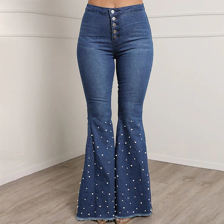 High-waisted blue flared jeans with button fly and pearl embellishments on legs