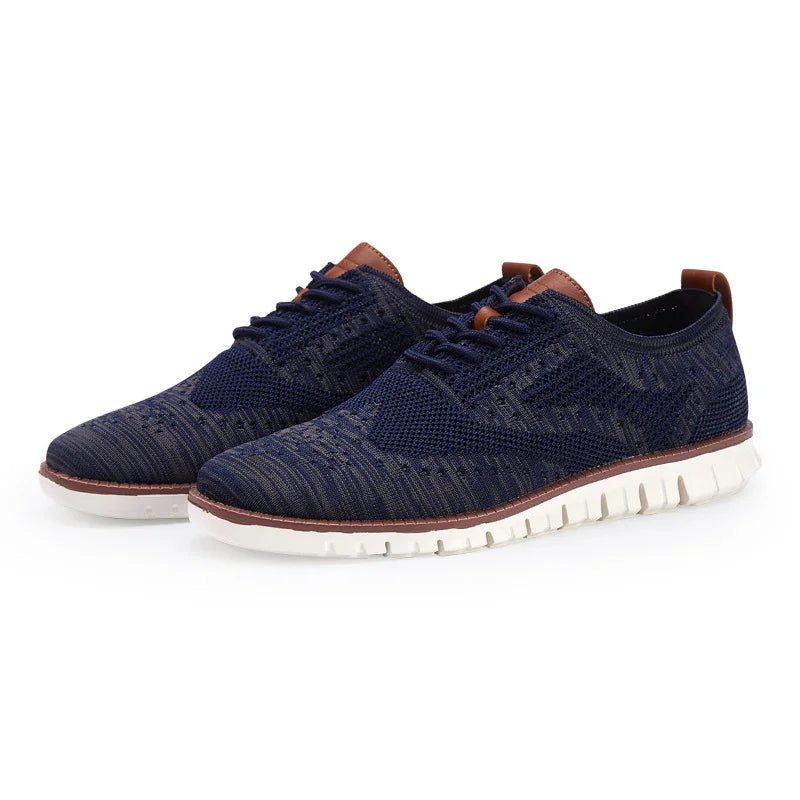 Navy blue knit lace-up casual shoes with white flexible sole and brown leather accents