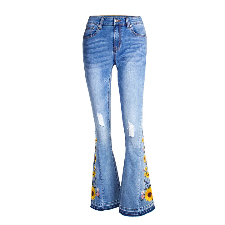 Light blue distressed flared denim jeans with sunflower embroidery on the lower legs