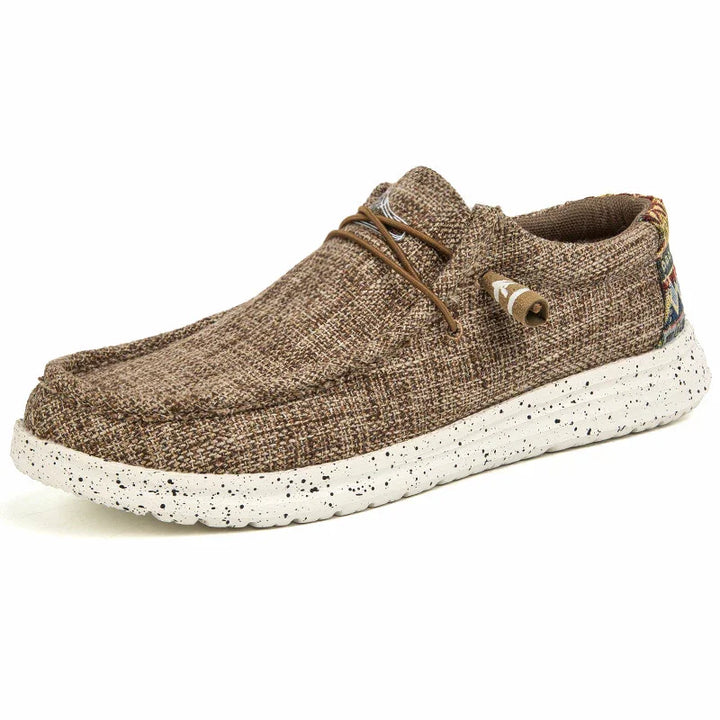 Brown woven casual shoe with speckled white sole and leather laces on white background
