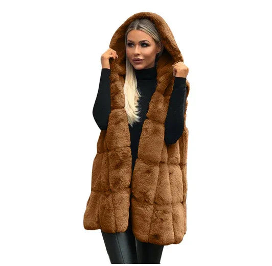 Woman wearing brown fur hooded sleeveless vest over black long sleeve top and pants
