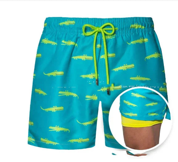 Blue swim shorts with yellow alligator print and neon green drawstring with inner lining shown