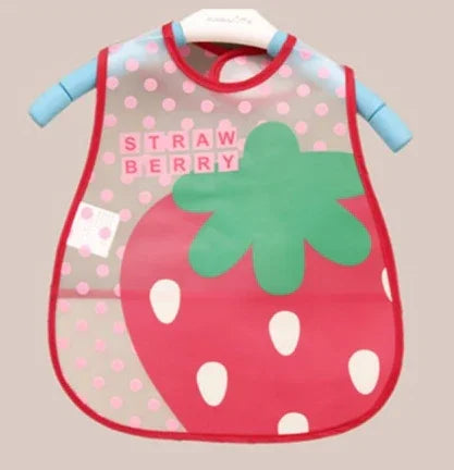 Children's strawberry-themed bib with pink polka dots and red trim on a hanger