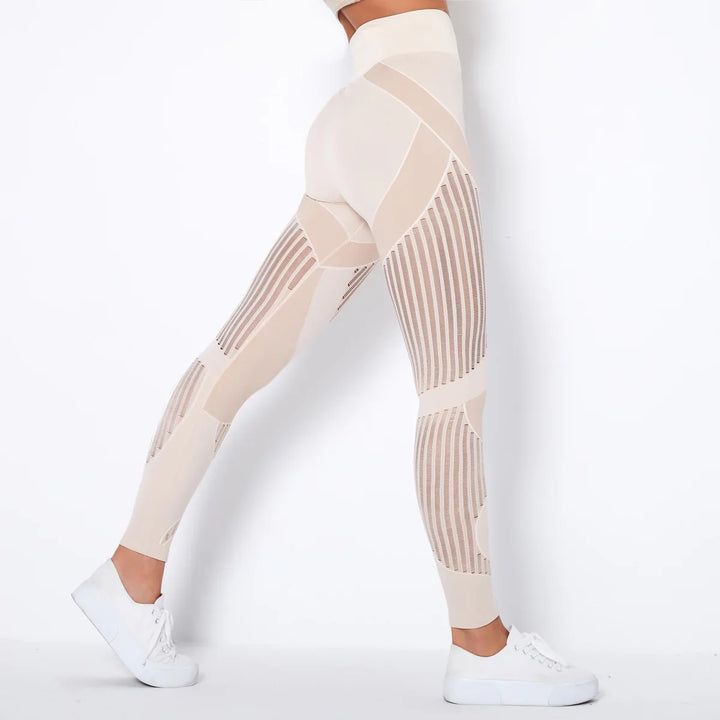 Woman wearing beige high-waisted seamless leggings with mesh panels and white sneakers