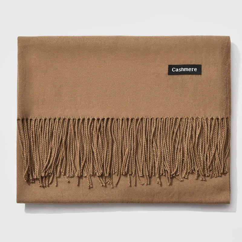 Folded camel brown cashmere scarf with twisted fringe on white background