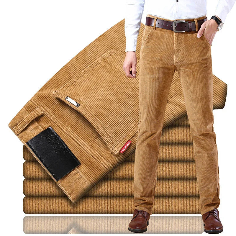 Men's brown corduroy pants with a brown belt, white shirt, and brown shoes stacked with folded pants