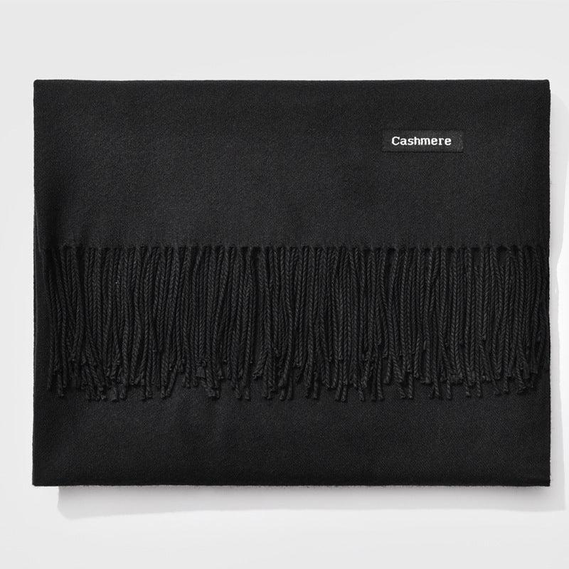 Black cashmere scarf with fringe detail and a small label reading 'Cashmere'