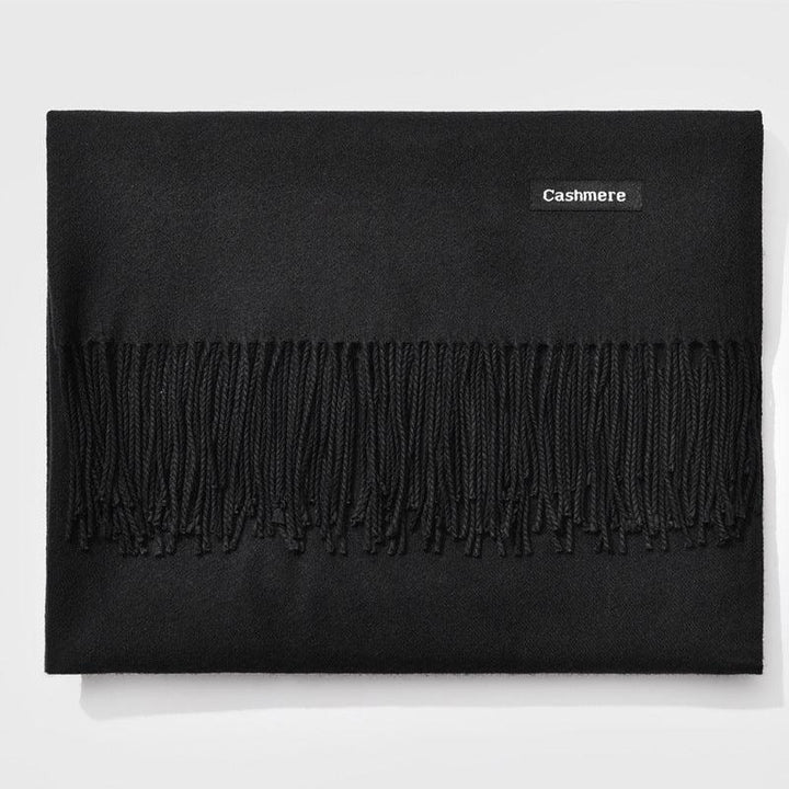 Black cashmere scarf with fringe detail and a small label reading 'Cashmere'